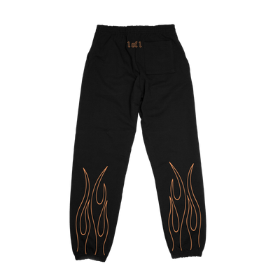 Back of black sweatpants with orange "1 of 1" tramp stamp and orange flames on bottom of both legs