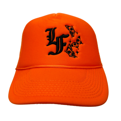 Close up image of the front of orange trucker hat with black font