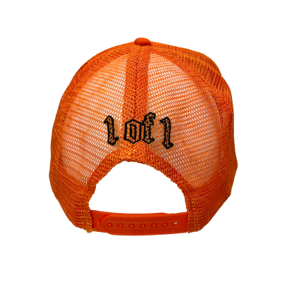 Close up image of the back of orange trucker hat with black font