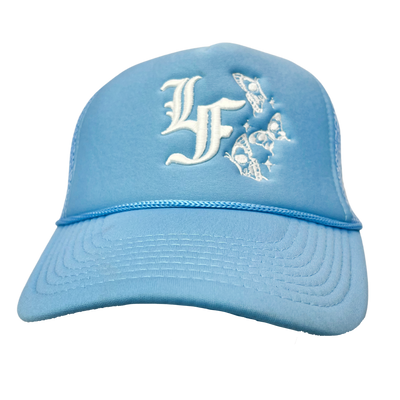 Close up image of front of blue trucker hat with white font