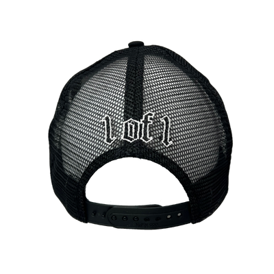 Close up image of the back of black trucker hat with white font