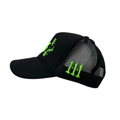 Close up image of the side of black trucker hat with green font