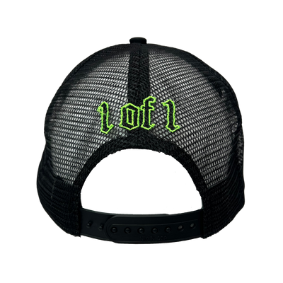 Close up image of the back of black trucker hat with green font