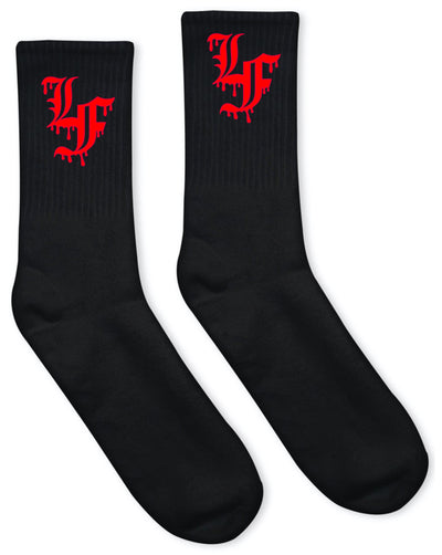 Close up  image of black socks with LF in red Old English font